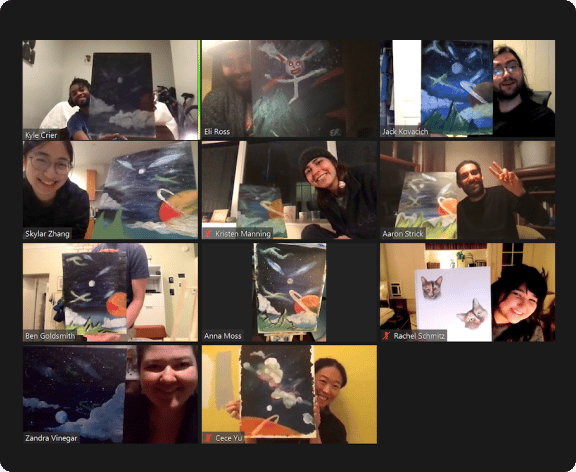 Zoom call of team members holding up paintings they made